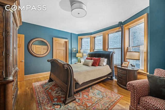 bedroom with wood finished floors and baseboards