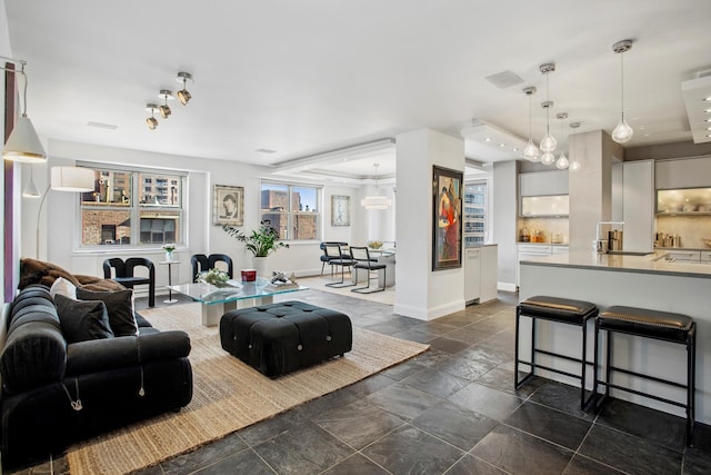 living room featuring baseboards and stone finish floor