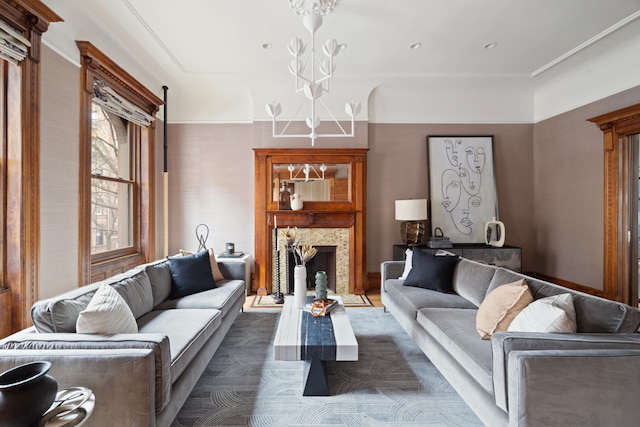 living room with a notable chandelier and a fireplace