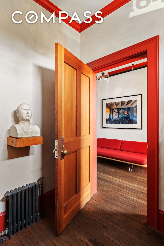 hall featuring radiator heating unit and wood-type flooring