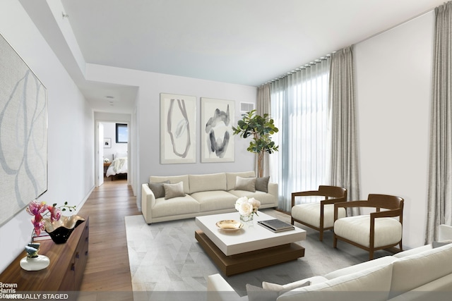 living area featuring wood finished floors and visible vents