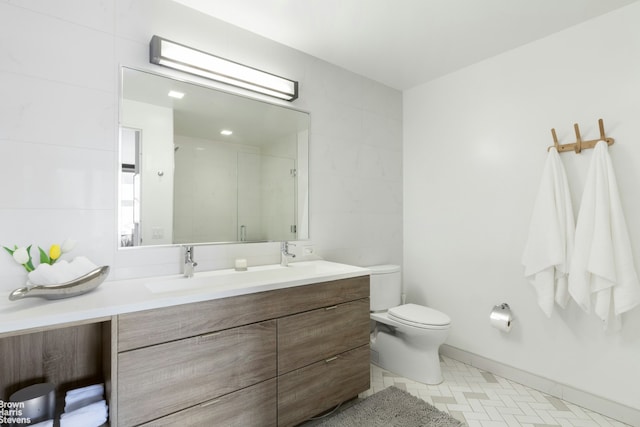 full bathroom featuring a stall shower, toilet, tile walls, and double vanity