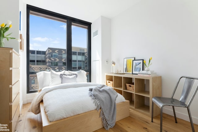 bedroom with wood finished floors and visible vents