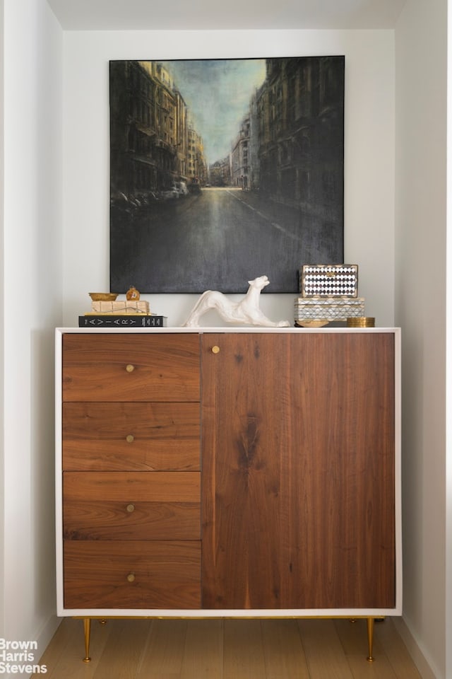 room details featuring baseboards and wood finished floors