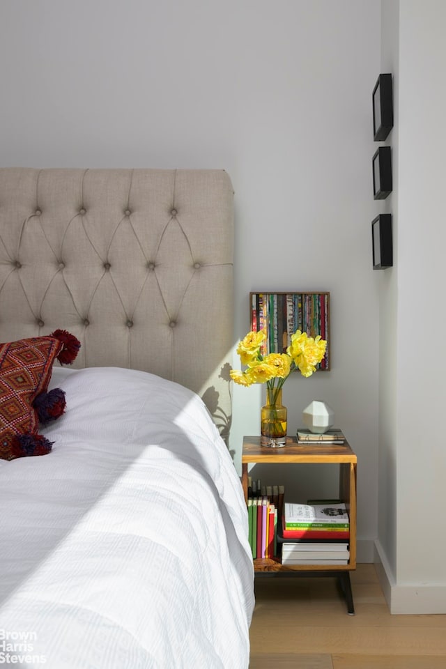 bedroom featuring baseboards and wood finished floors