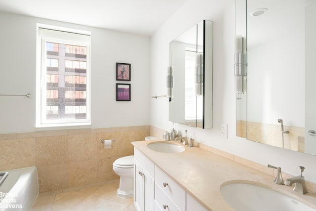 bathroom featuring a sink, tile walls, and a healthy amount of sunlight