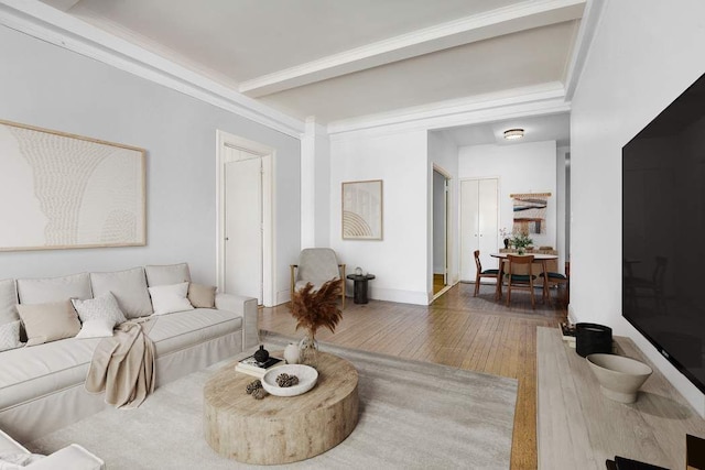 living room featuring beam ceiling, baseboards, wood-type flooring, and ornamental molding