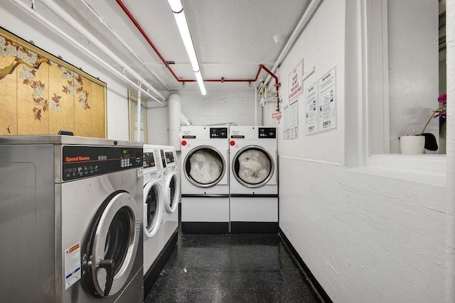 community laundry room with washing machine and clothes dryer