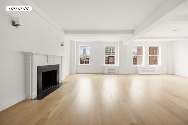 unfurnished living room featuring baseboards, a fireplace with flush hearth, light wood-style flooring, and beam ceiling