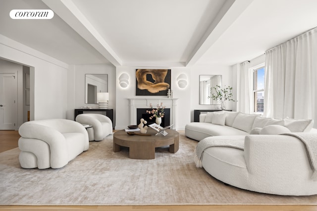 60 Gramercy Park N Unit 16A, New York City, NY 10010 - unfurnished living room with light wood-type flooring, a fireplace with flush hearth, baseboards, and beamed ceiling