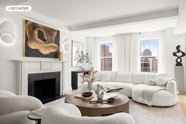 60 Gramercy Park N Unit 16A, New York City, NY 10010 - unfurnished living room featuring light wood-type flooring, a fireplace with flush hearth, and baseboards
