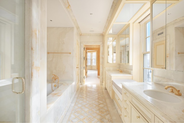 bathroom featuring a garden tub, a stall shower, ornamental molding, a sink, and double vanity