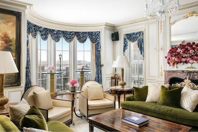 living room with crown molding and a chandelier