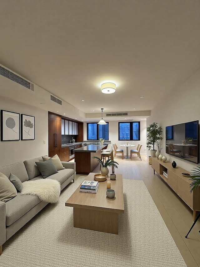 living room featuring visible vents and light wood-type flooring