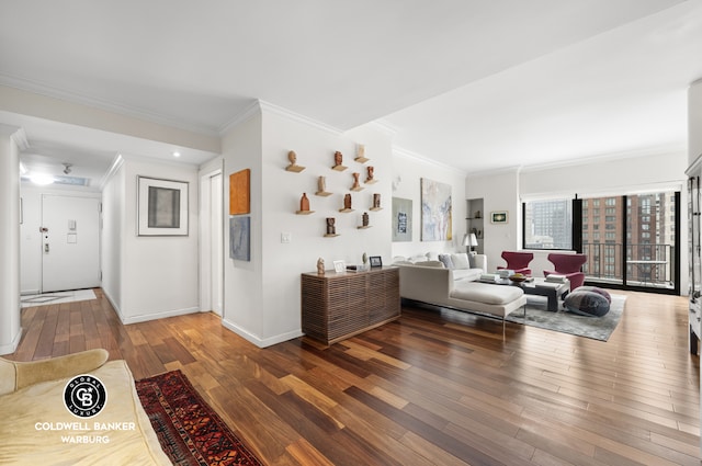 living area with baseboards, wood finished floors, and ornamental molding