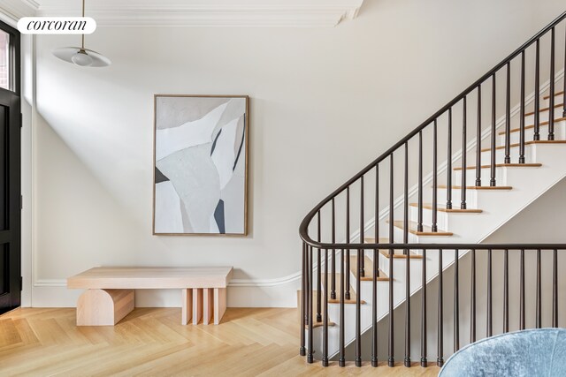 stairway with visible vents and ornamental molding