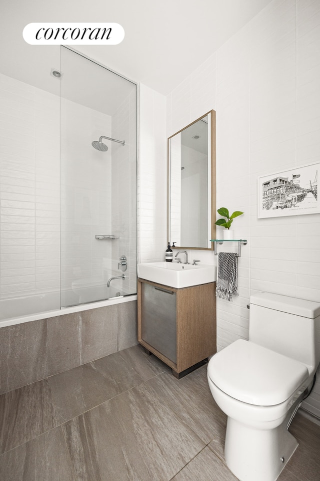 bathroom with shower / bathing tub combination, toilet, and vanity