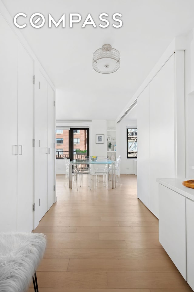 corridor with light wood-type flooring