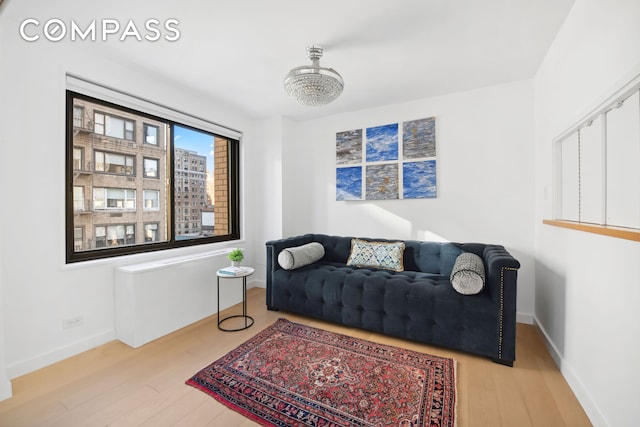 living area featuring baseboards and wood finished floors