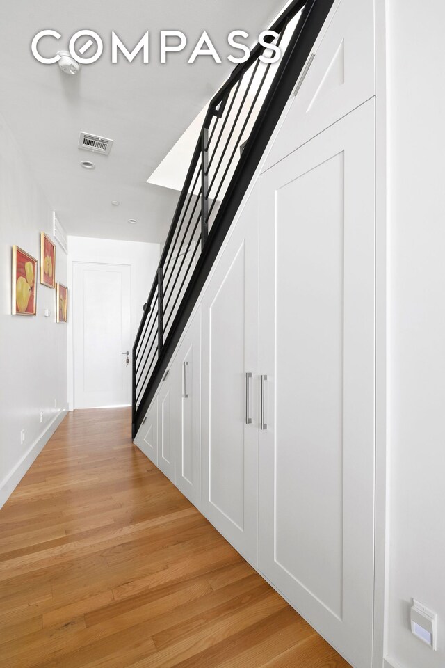 172 Wilson Ave Pha, Pha, New York City, NY 11237 - hallway featuring light wood finished floors and stairs