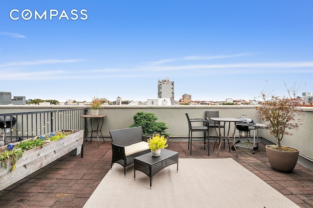 view of patio / terrace with a view of city and a balcony