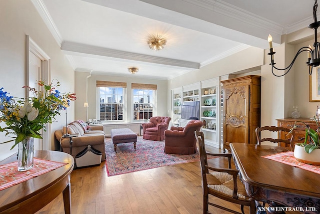 living area with beam ceiling, crown molding, and hardwood / wood-style flooring