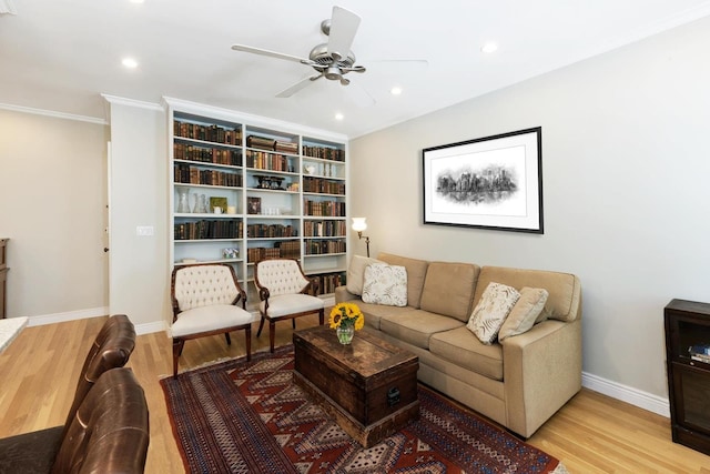 living area with baseboards, ornamental molding, recessed lighting, wood finished floors, and a ceiling fan