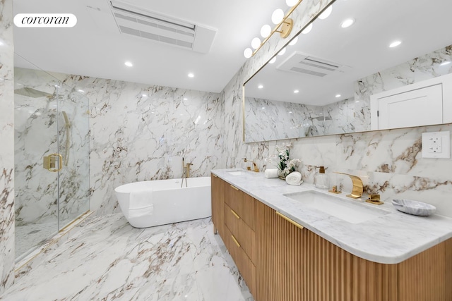 full bath with stone wall, marble finish floor, a marble finish shower, and a sink