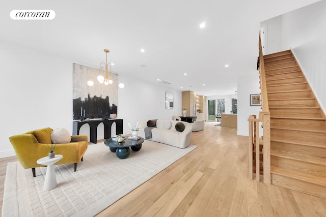 living area featuring light wood-type flooring, visible vents, a notable chandelier, recessed lighting, and stairway