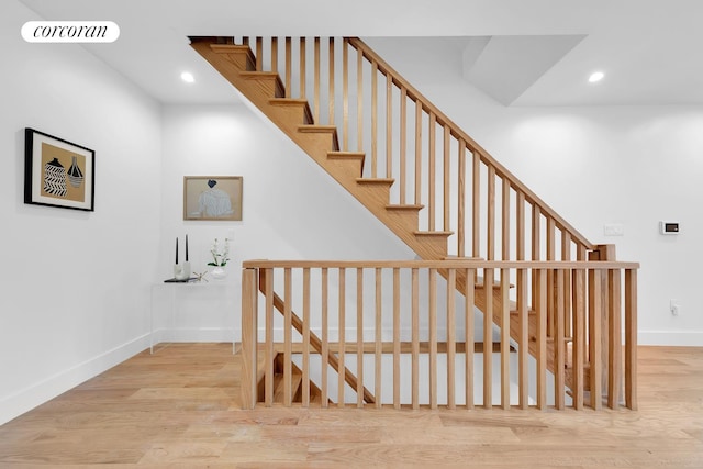 stairs with recessed lighting, wood finished floors, visible vents, and baseboards