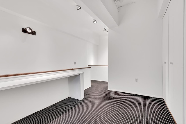 spacious closet featuring dark colored carpet