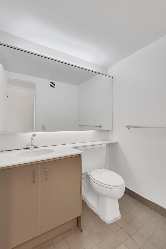 half bathroom featuring vanity, toilet, baseboards, and visible vents