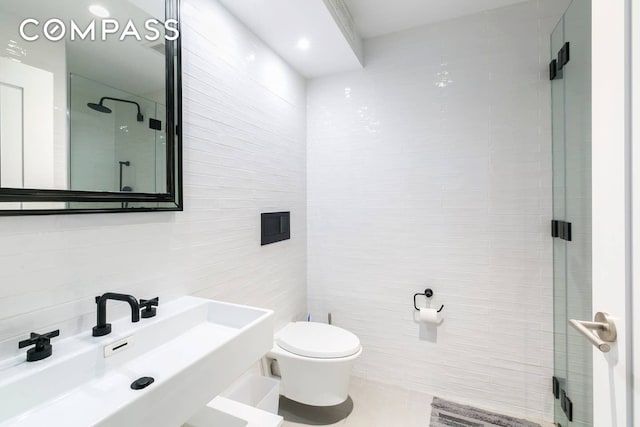 full bathroom featuring a sink, tile walls, toilet, a shower stall, and tile patterned flooring