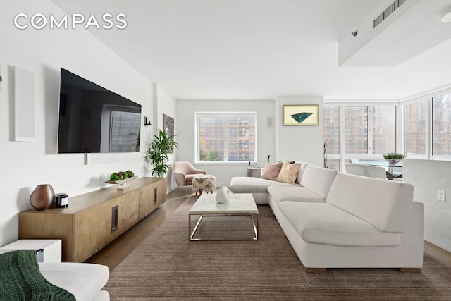 living room featuring wood finished floors and visible vents