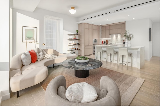 living area with recessed lighting and light wood-type flooring