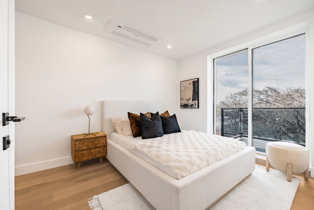 bedroom featuring recessed lighting, access to exterior, light wood finished floors, and baseboards
