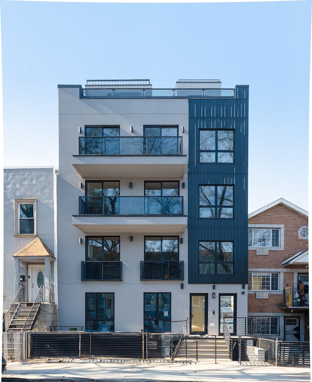 view of building exterior with a fenced front yard