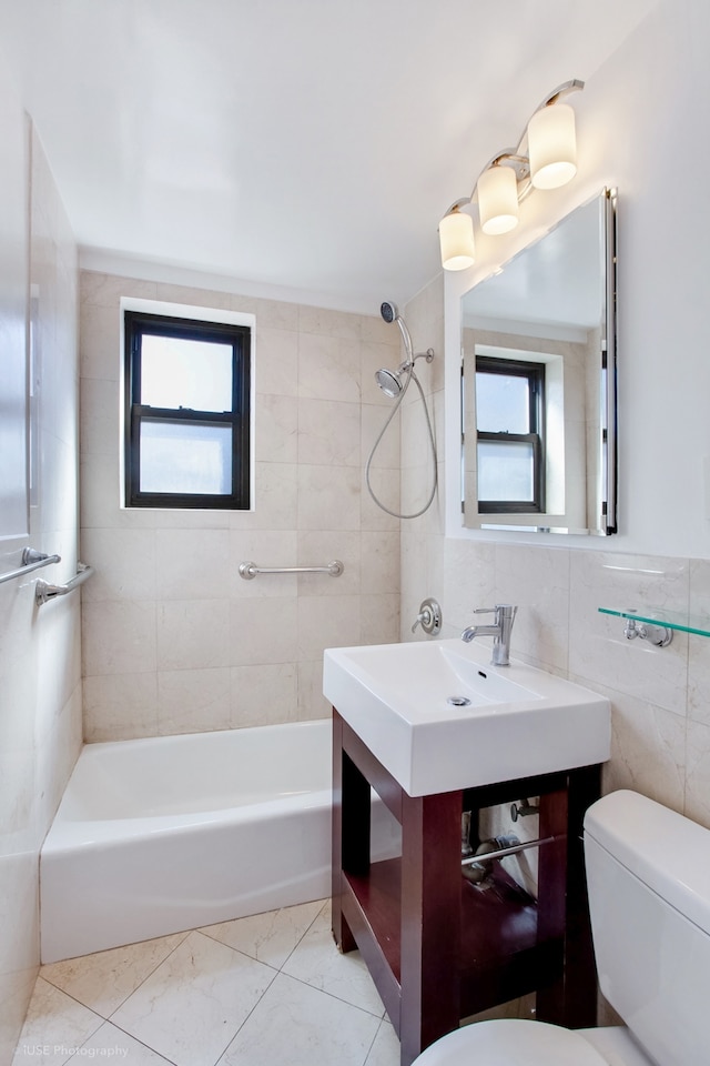 bathroom featuring toilet and tile walls