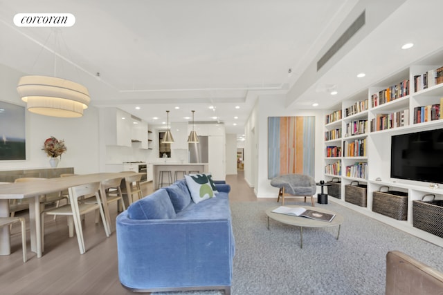 12 W 18th St Unit 4E, New York City, NY 10011 - living area featuring light wood-style floors, recessed lighting, and built in features