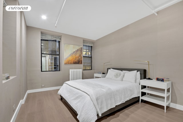 12 W 18th St Unit 4E, New York City, NY 10011 - bedroom with radiator heating unit, wood finished floors, and baseboards
