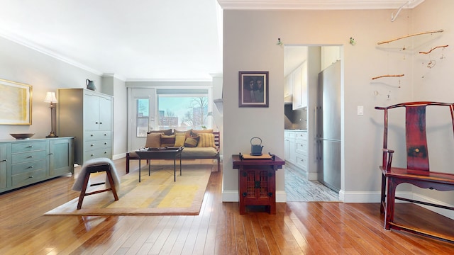 interior space with baseboards, wood-type flooring, and ornamental molding