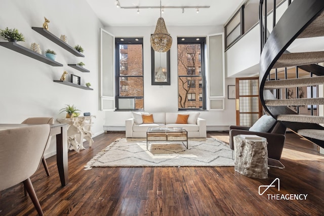 250 Mercer St Unit D203, New York City, NY 10012 - living room featuring track lighting, wood finished floors, baseboards, and a chandelier