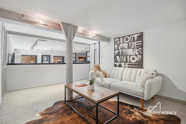 living room featuring baseboards, carpet, and track lighting