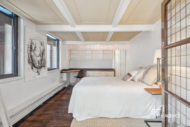 bedroom with dark wood finished floors, beamed ceiling, and built in study area