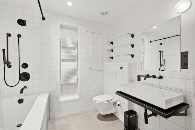 bathroom with tile walls, a sink, tile patterned floors, toilet, and radiator heating unit
