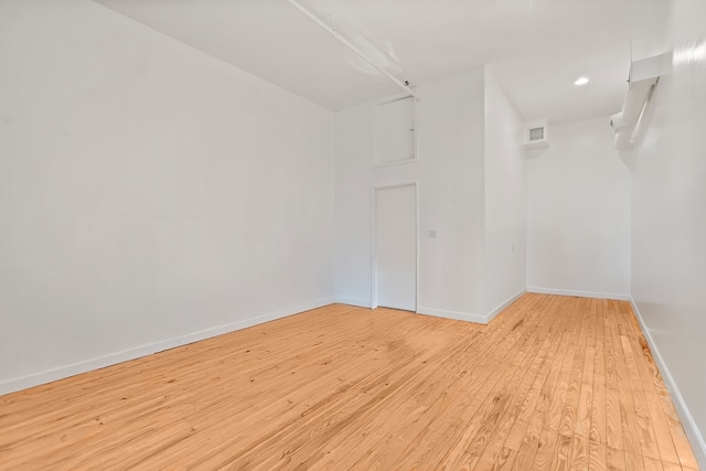 empty room with visible vents, recessed lighting, baseboards, and light wood-type flooring