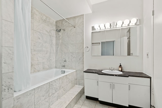 bathroom featuring vanity and tiled shower / bath