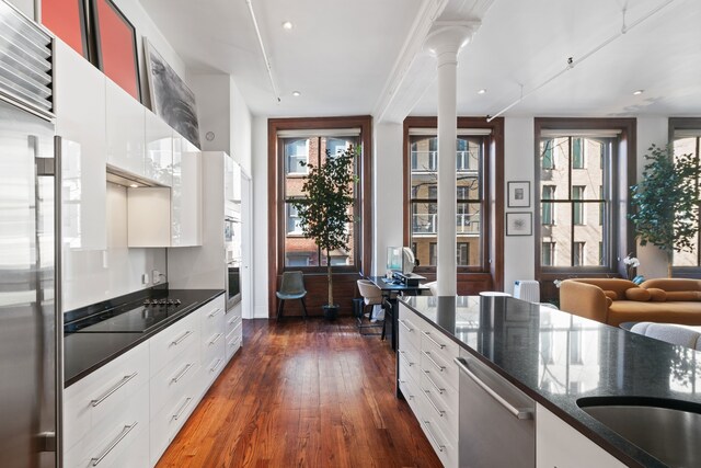 kitchen with white cabinets, dark wood-style flooring, and appliances with stainless steel finishes