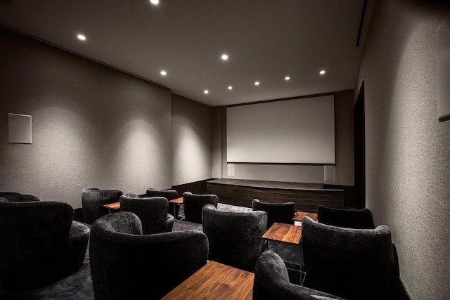 home theater with recessed lighting, a textured wall, and wood finished floors