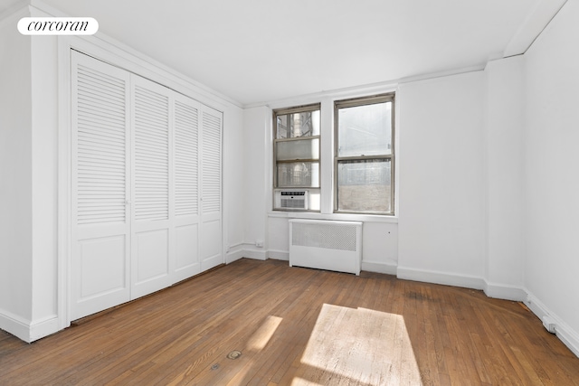 71 Park Ave Unit 3C, New York City, NY 10016 - unfurnished bedroom with radiator, hardwood / wood-style floors, and baseboards